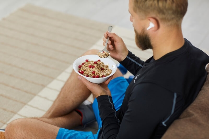 Athlete enjoying healthy pre workout meal on a bowl