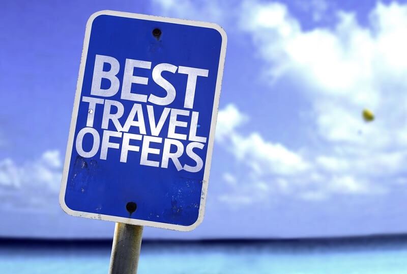 Best Travel Offers sign with a beach on background