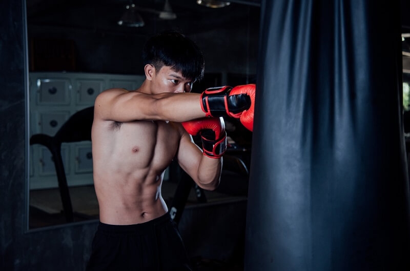 Boxer practicing boxing drills on a punching bag