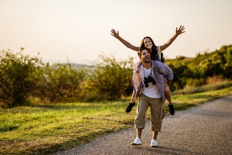 Boyfriend giving piggyback ride to girlfriend