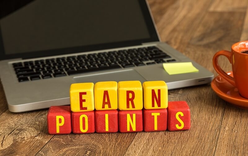 Earn Points written on a wooden cube in a office desk