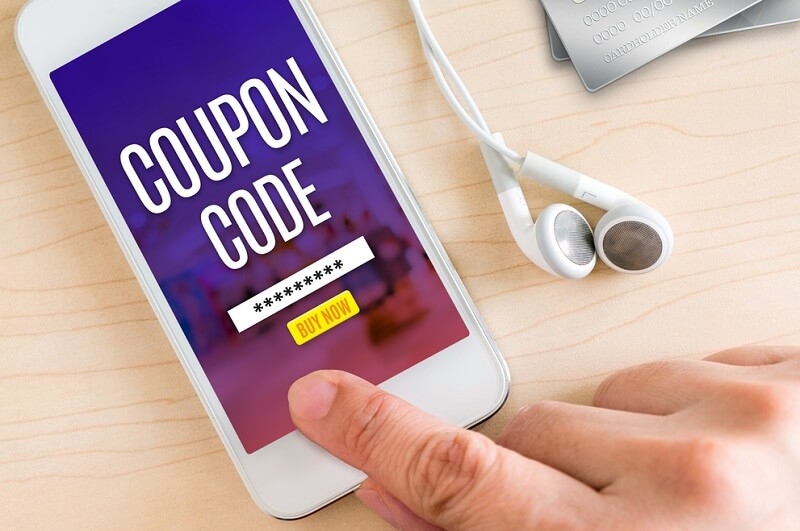 Hand touching smart phone with Coupon code on screen