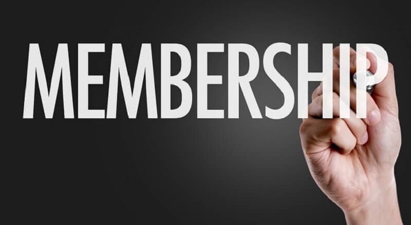 Hand writing the text Membership in black background