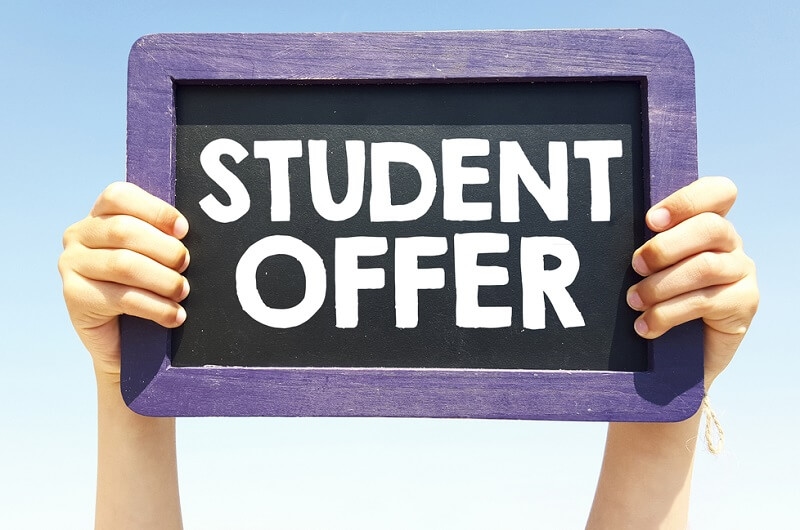 Hands holding blackboard with handwritten student offer