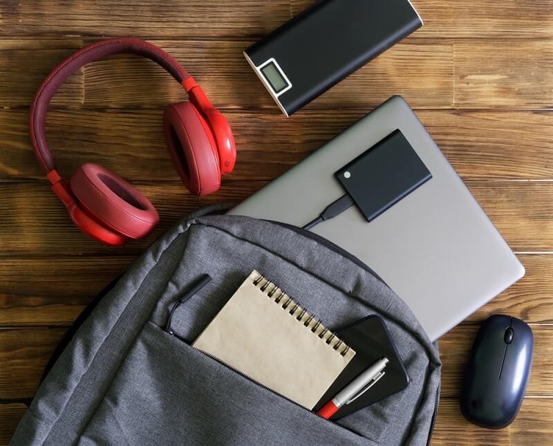 Laptop, smartphone, notepad, pen, headphones etc. in backpacks