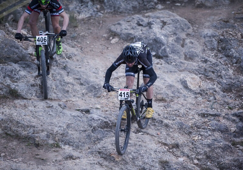 Male Cyclist competing on Cyclocross race. going through hills