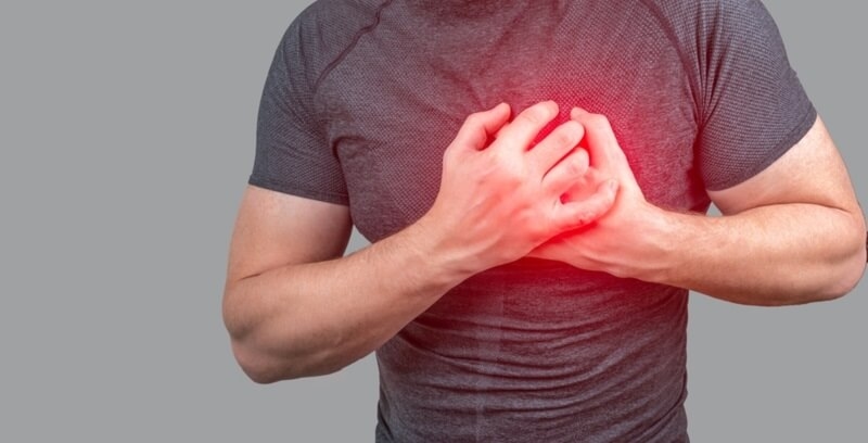 Man clutching his chest from acute pain