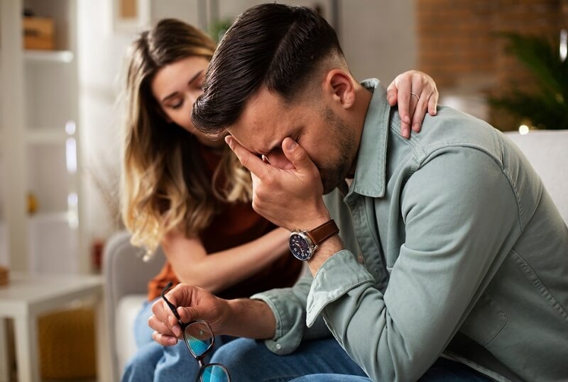 Man in Grief, Girlfriend comforting her sad boyfriend