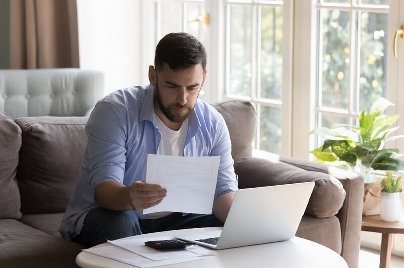 Man looking at financial documents