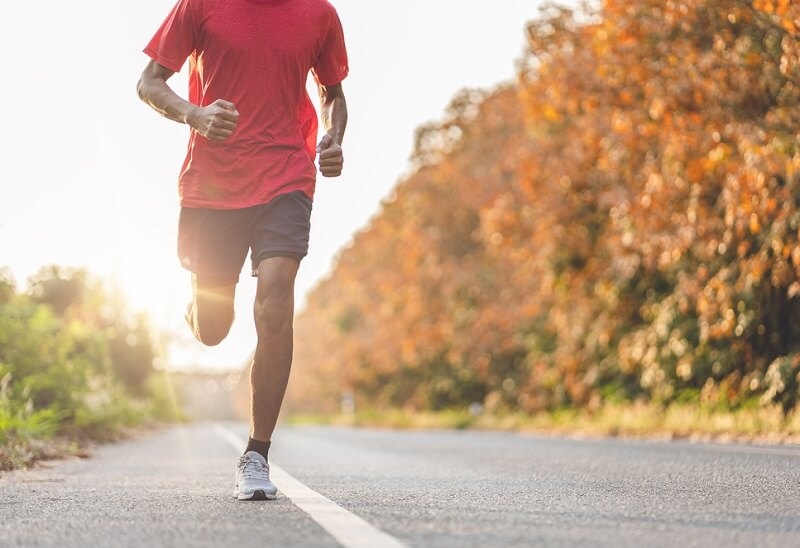 Man running on road doing exercise