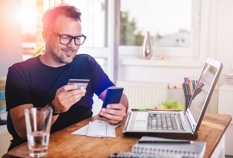 Man using credit card to buy online