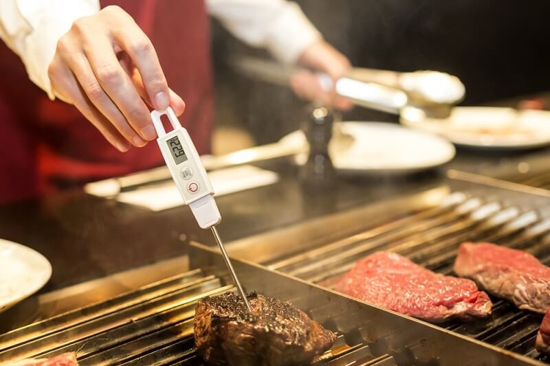 Measuring steak temperature on a grill with Digital Meat Thermometer