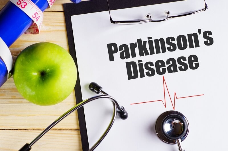 Parkinson's disease text on a notepad with a stethoscope