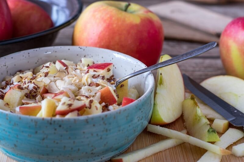 Pre-Workout meal with hazelnuts served with linseed and apples in a bowl