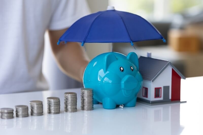 Protection, pile of coins and mockup house with umbrella financial insurance
