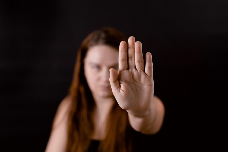 Serious woman show personal boundaries putting palm forward