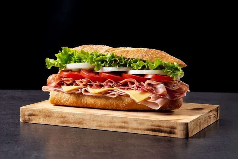 Submarine sandwich with ham, cheese, lettuce, tomatoes,onion, mortadella and sausage