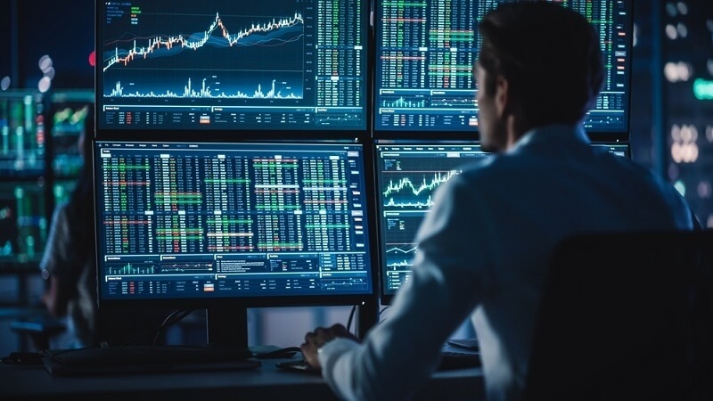 Traders Working on a Computers with Multi-Monitor Workstations