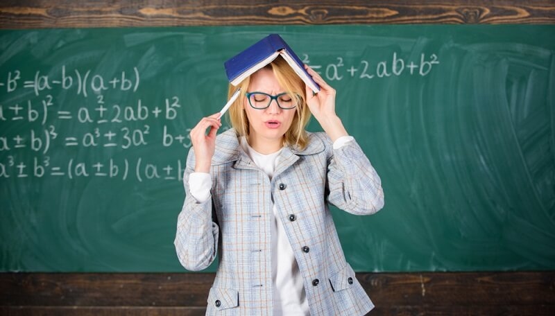Woman with book as roof on head Memorizing something