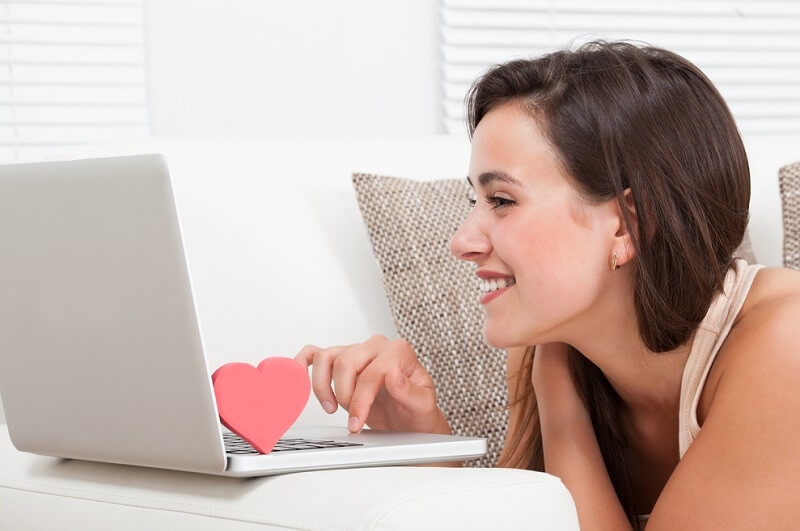 beautiful woman dating online on laptop at home