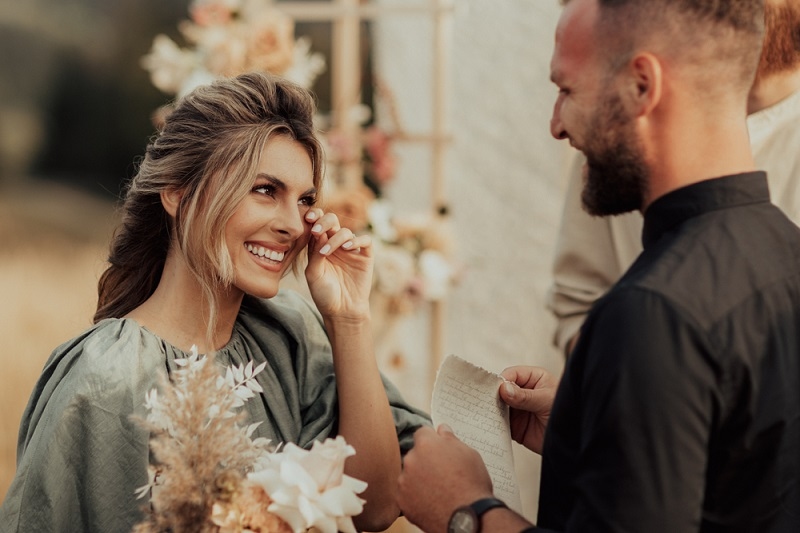 Bride wipes away her tears of emotion