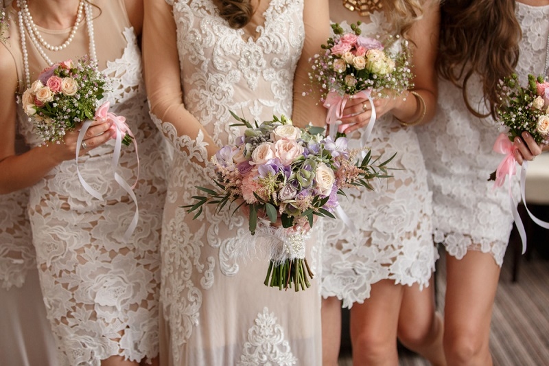 bride and bridesmaids holding their bouquets at wedding day