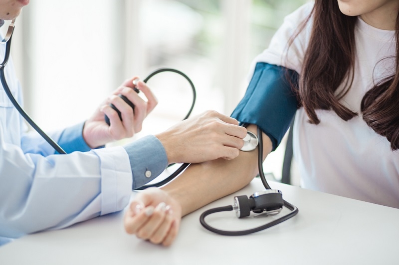 Doctor checking blood pressure to a patient