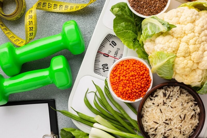 flat lay of vegetables, measuring tape and weights