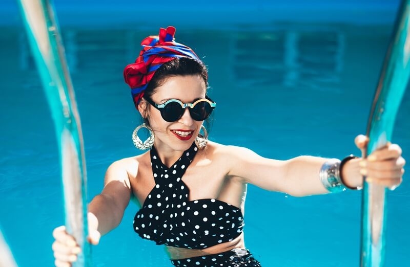 girl by the pool with a black retro bathing suit