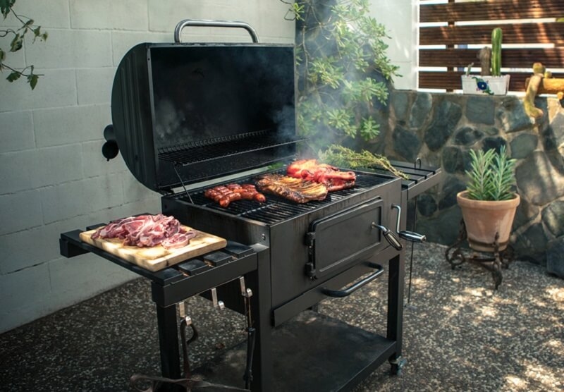 grilling barbecue in backyard of house