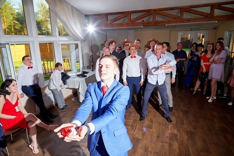 The groom with the bride's garter.