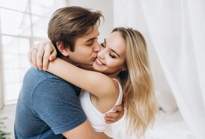 guy kissing and holding his girlfriend in his arms