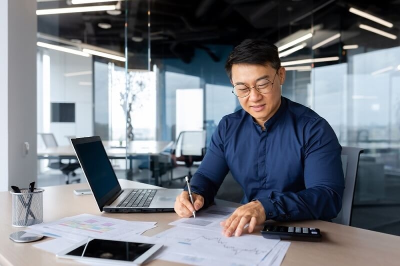 investor working with documents and charts inside office