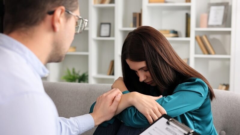 male professional psychologist tries to comfort patient with Anxiety Disorders