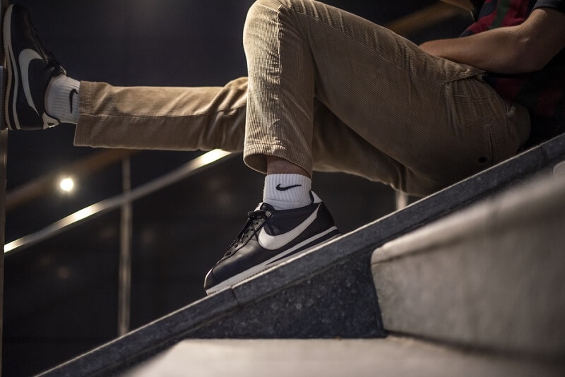 man wearing Nike Cortez classic shoes in the street