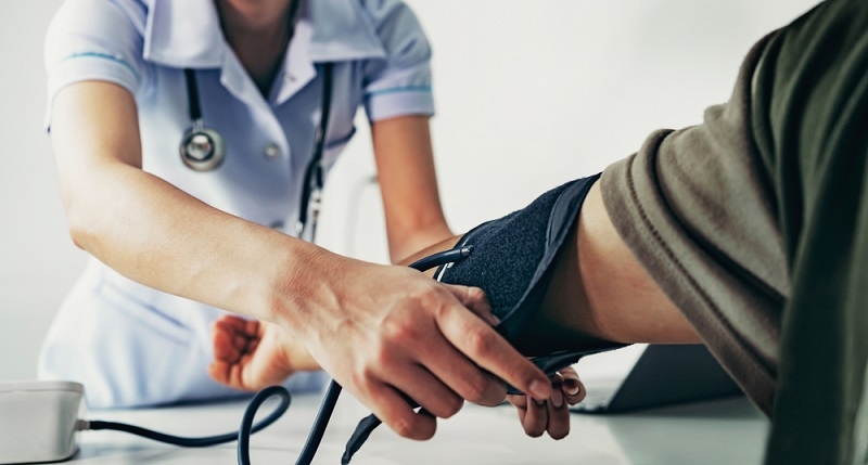 Nurse measuring arterial blood pressure