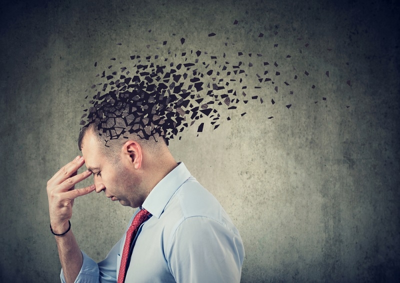 sad man losing parts of head as symbol of dementia 