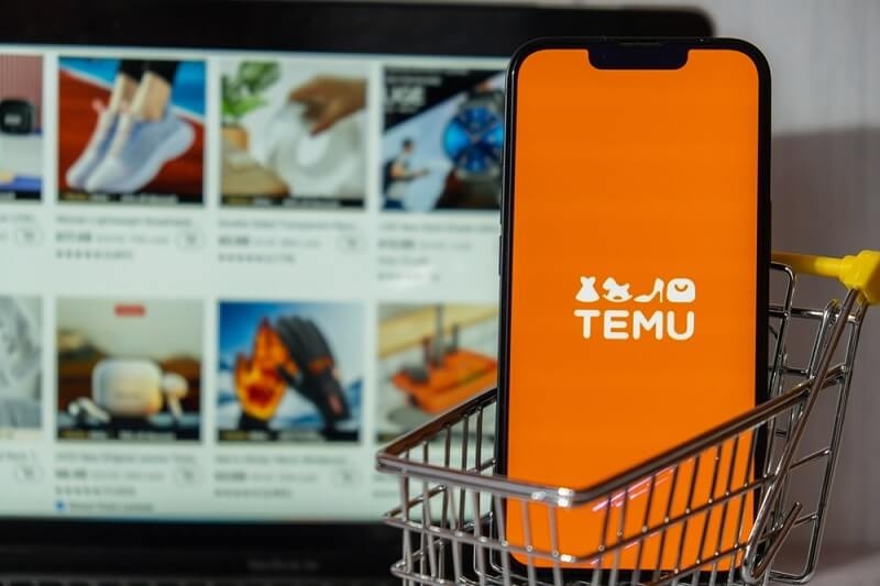 mobile in shopping cart with Temu logo