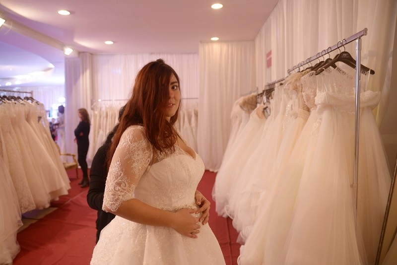 Bride to be trying on dresses