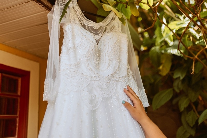 plus size white wedding dress hanging outdoors