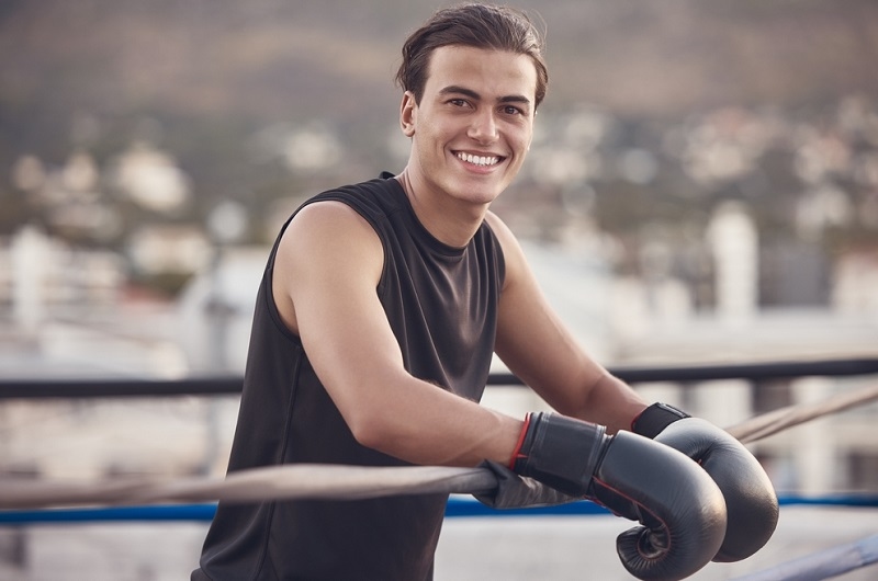 New boxer in ring with gloves smiling