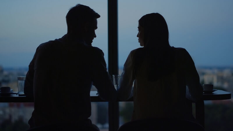 silhouettes of couple talking to each other