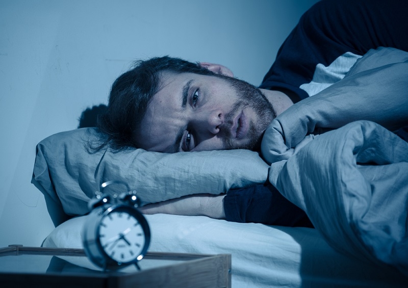 Sleepless man awake at night not able to sleep