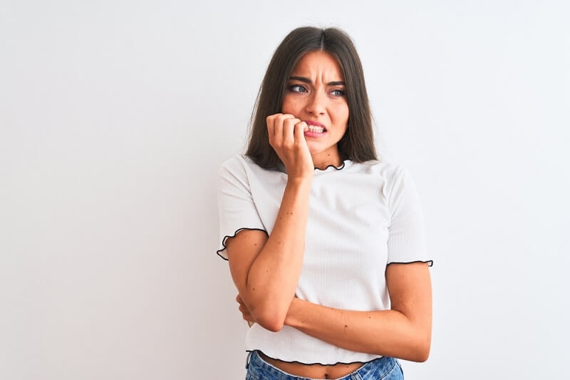 stressed and nervous woman biting nails. Anxiety problem