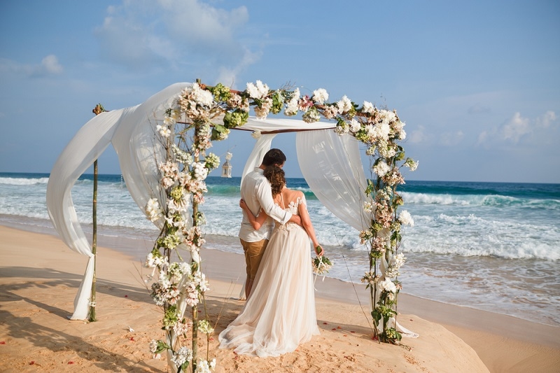 Bride and groom enjoying beach wedding in tropics