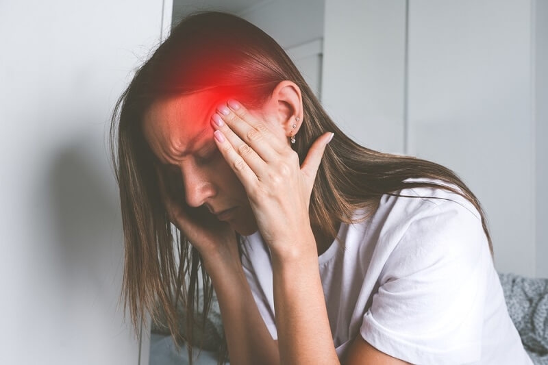 woman touching her temples and suffering from head pain, headache