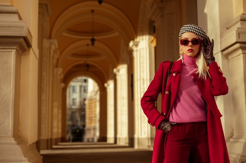 woman wearing sunglasses, pink turtleneck cashmere sweater