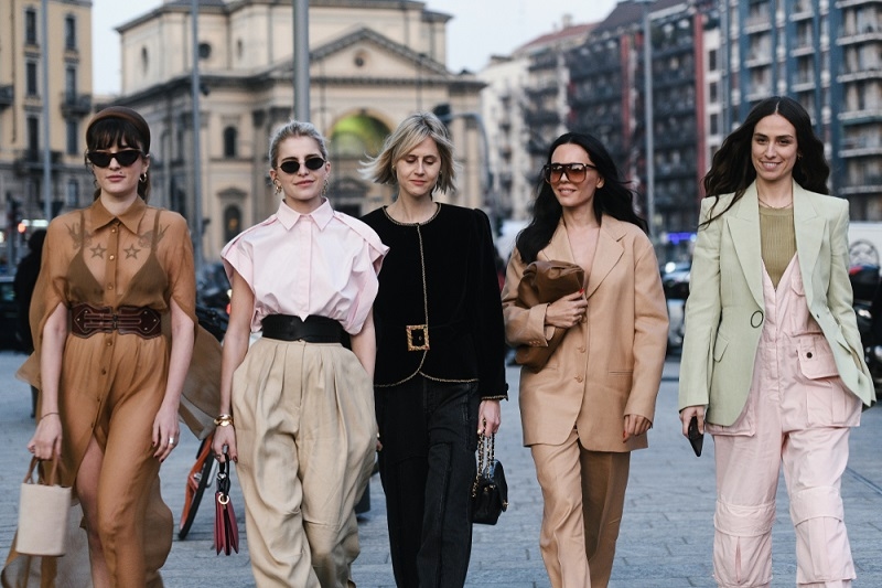 women wearing different outfits walking on street