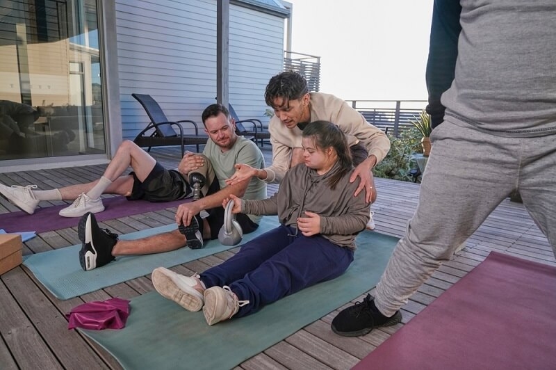 coach giving extra time and efforts to disabled girl