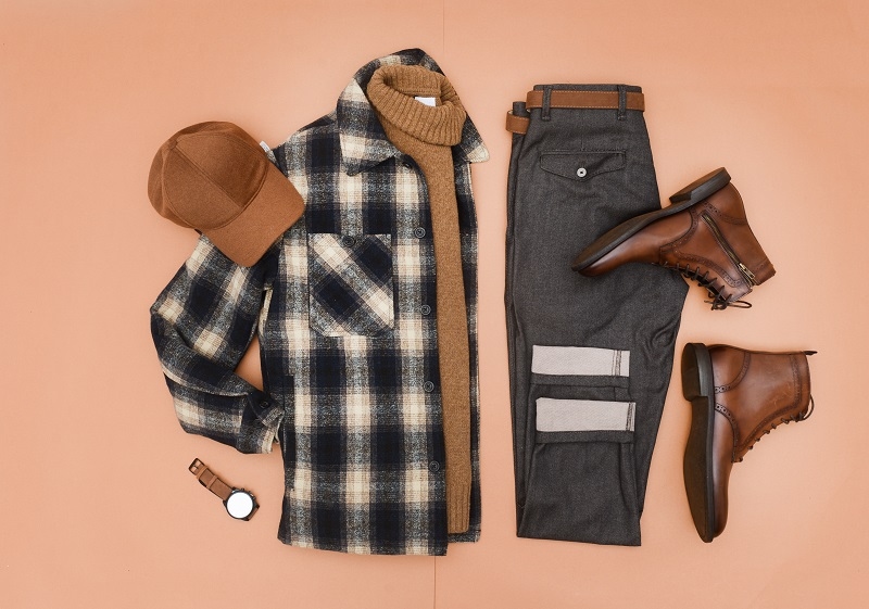 Men's striped shirt and accessories on brown background, flat lay
